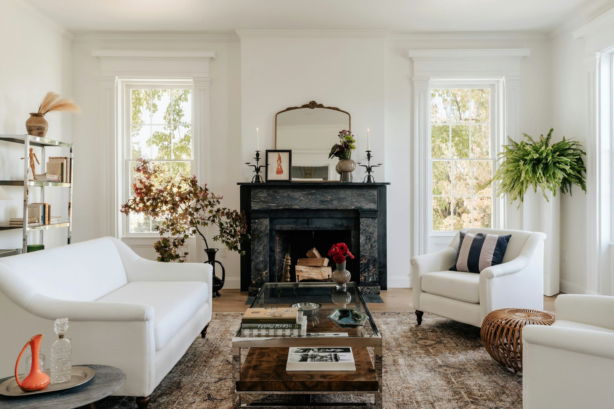 A white drawing room with a black marble fireplace
